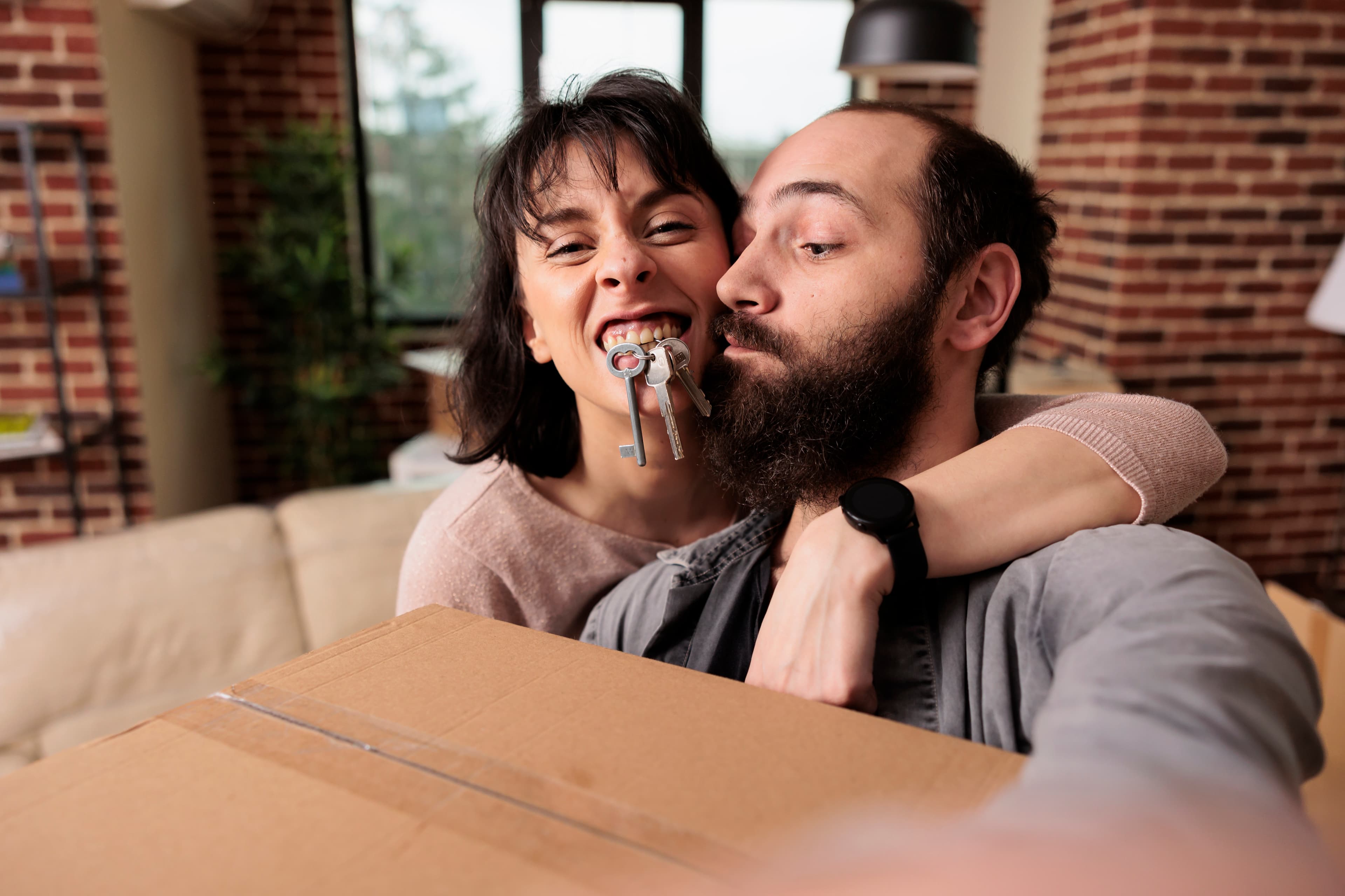 Married couple with the keys to their first home